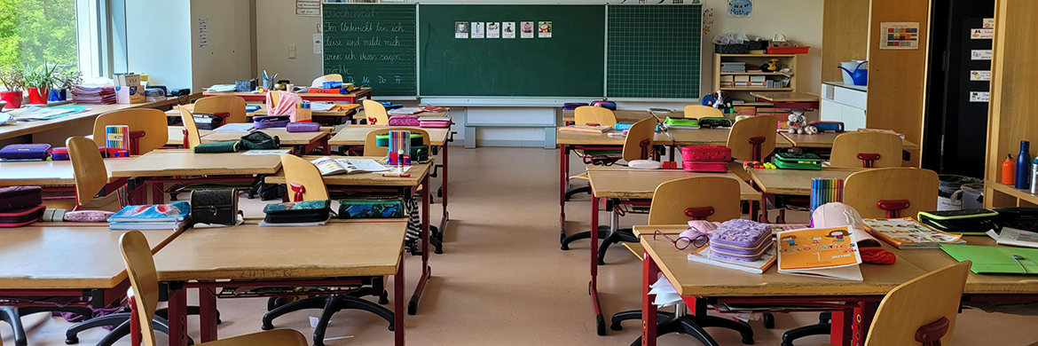 Empty classroom with chalkboard at the front