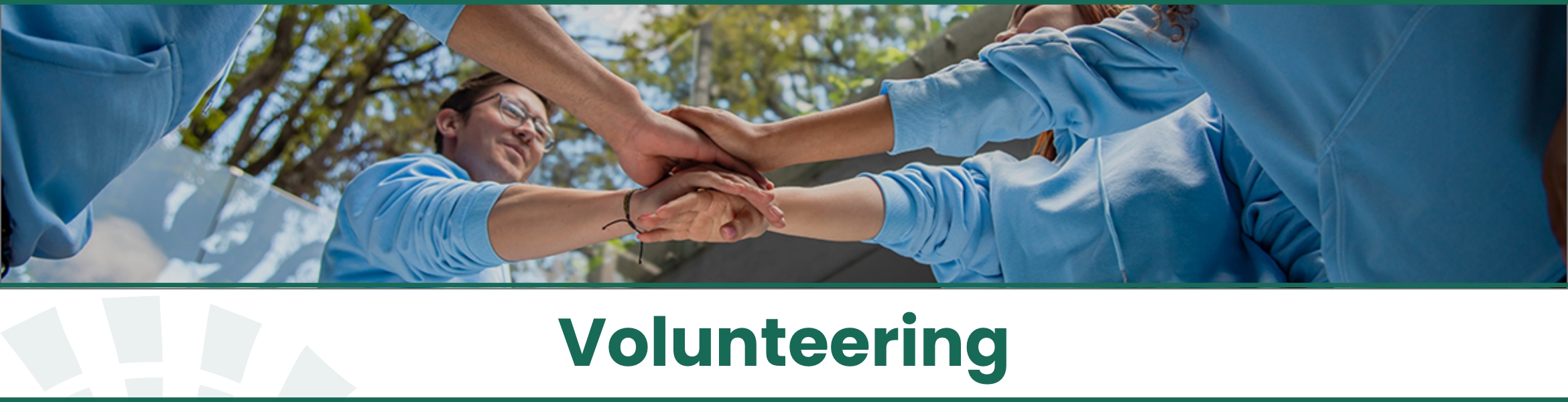 Group of volunteers stacking their hands together