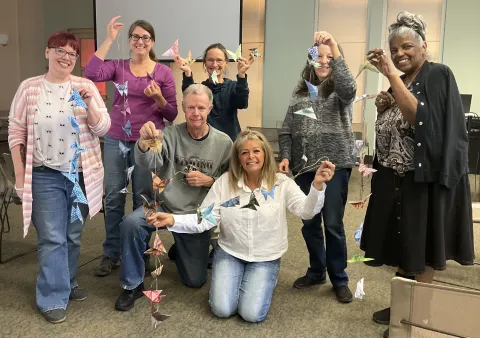 Seniors holding up crafts they made