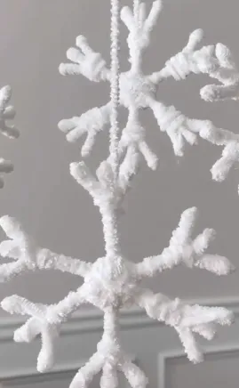 Image of completed white yarn snowflakes
