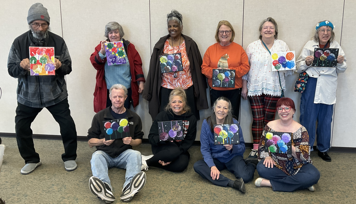 Seniors holding up their painting