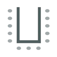 Tables in a U-shape with chairs around outside edges.